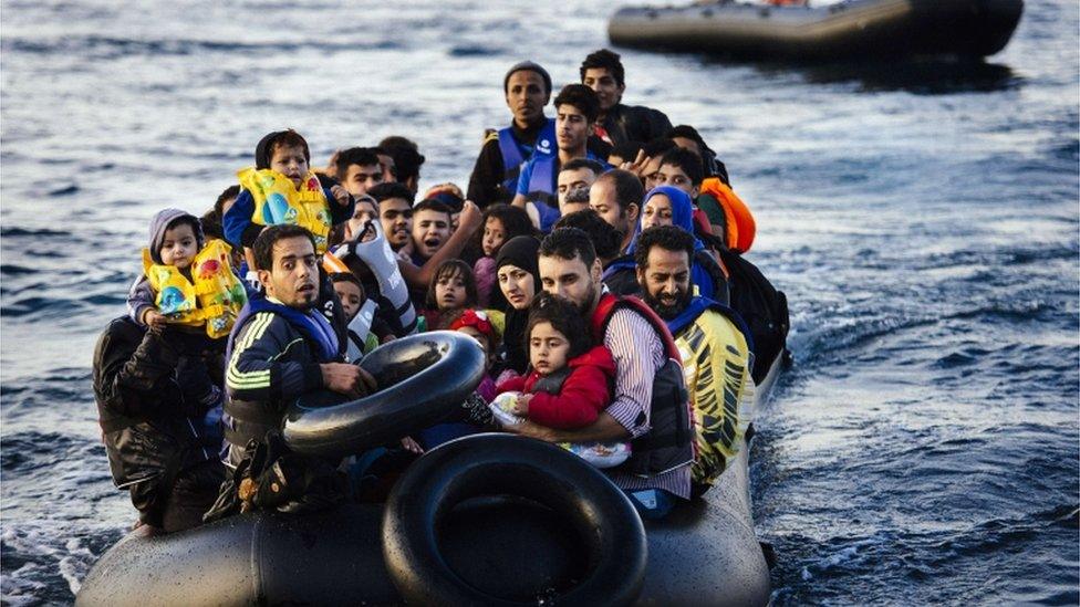 Migrants arriving by boat at Lesvos