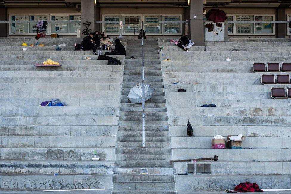 Demonstrators gather in the stand at the Sir Philip Haddon-Cave Sports Field during a protest at the Chinese University of Hong Kong (CUHK) in Hong Kong, China, on Friday, Nov. 15, 2019.