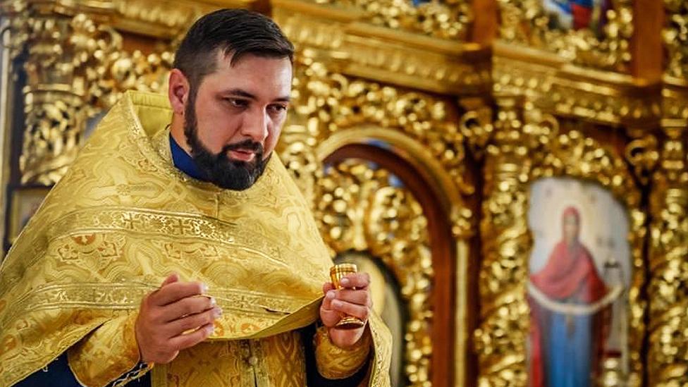 Father Nicolay Pluzhnik in his church in Chuhuiv, in the Kharkiv region, before he fled west