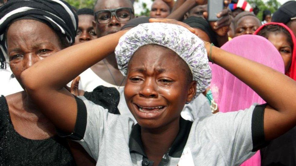 Relatives mourning at funeral service