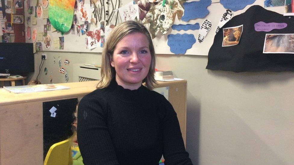 Nicola Cannon wearing a black jumper, and sitting in an office at the nursery