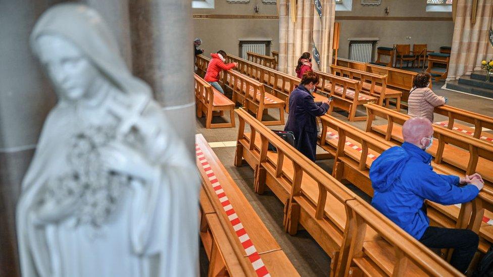 Members of the public pray at St Andrew Cathedral