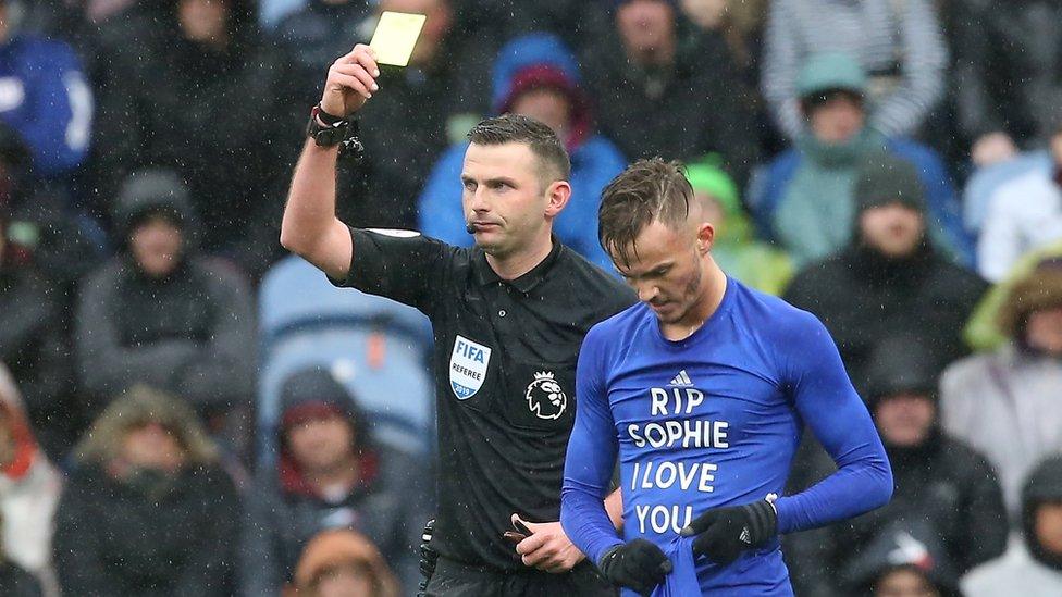 James Maddison of Leicester City is booked by referee Michael Oliver