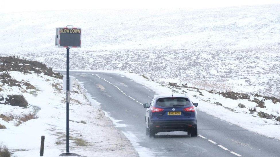 A car driving on a snowy road