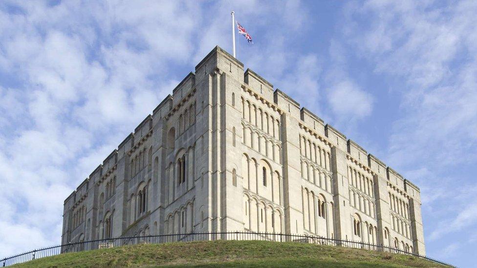 Norwich Castle on top of the mound. The Union Jack flag flies above.