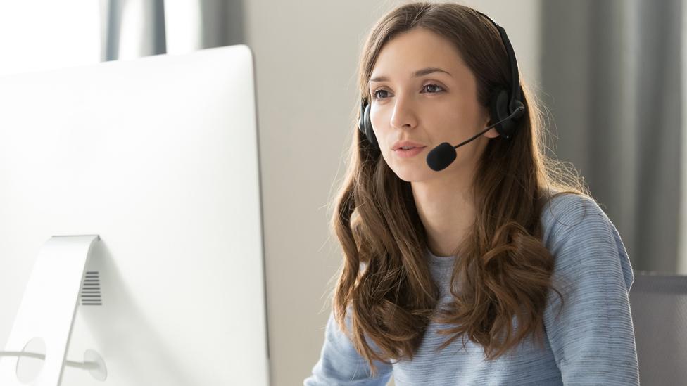 A woman with a phone headset