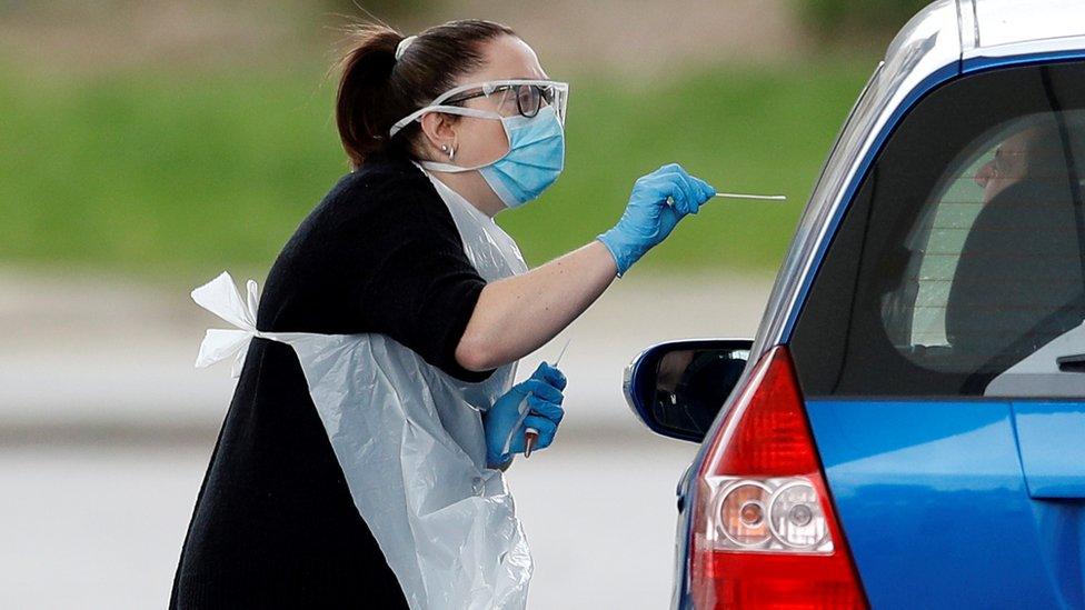 Medical staff at an NHS drive through coronavirus disease (COVID-19) testing facility in the car park of Chessington World of Adventures, as the spread of the coronavirus disease (COVID-19) continues, Chessington,