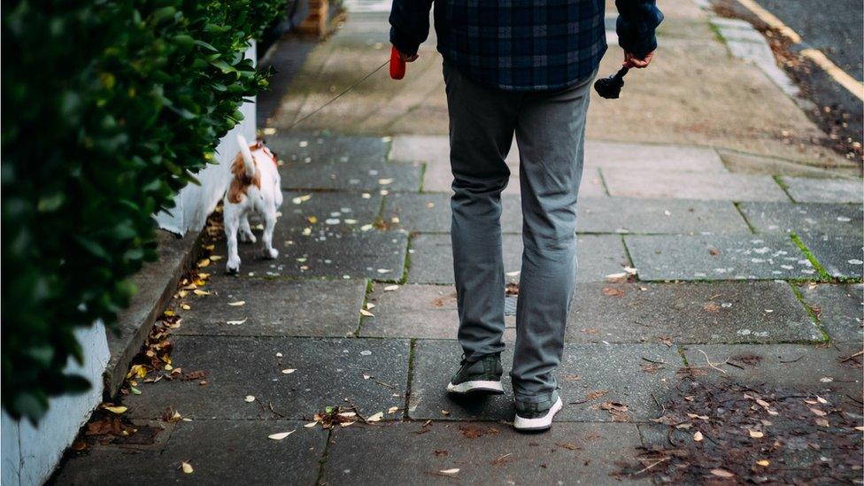 man walking on pavement