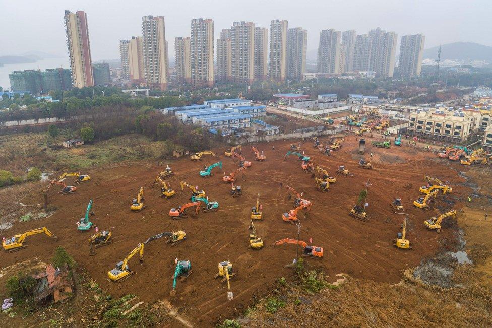 This aerial photo shows excavators at the construction site of a new hospital being built to treat patients from a deadly virus outbreak in Wuhan in China's central Hubei province.