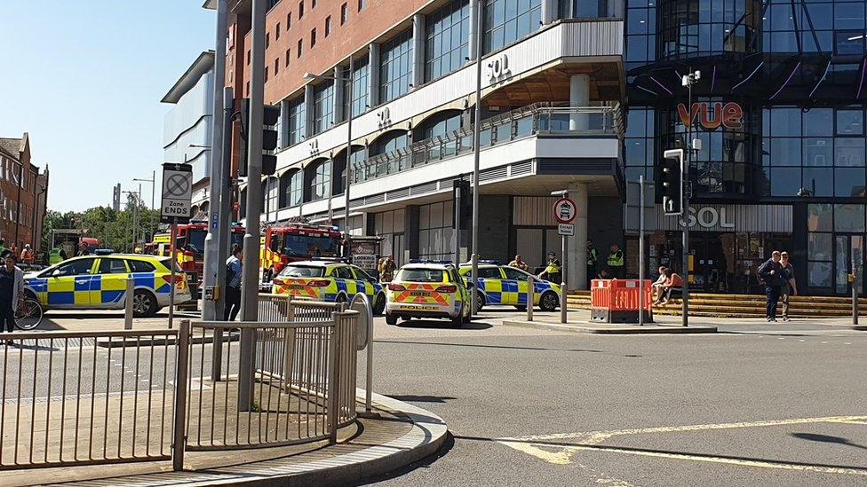 Several Police cars and fire engines in Northampton town centre.