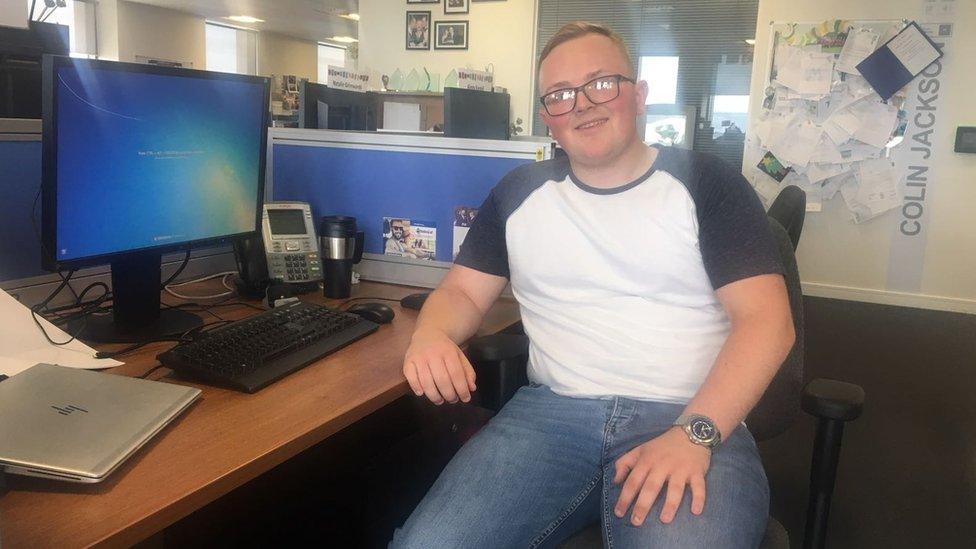 Ellis Cockram sitting at a desk