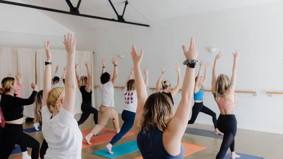 Lucy teaches a yoga class