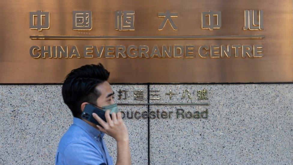 A man walks past the China Evergrande Centre in Hong Kong.