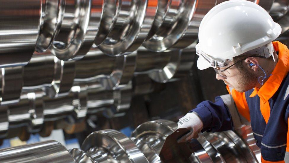 Steel worker cutting metal