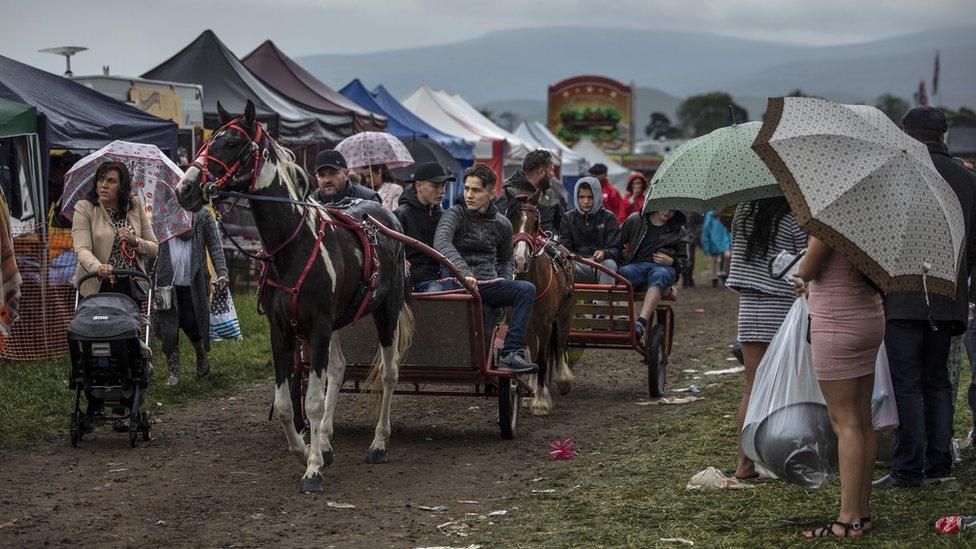 Horses and carts make their way through the stands during the annual Appleby Horse Fair