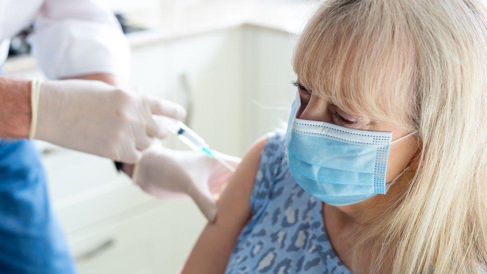 Woman being vaccinated against Covid