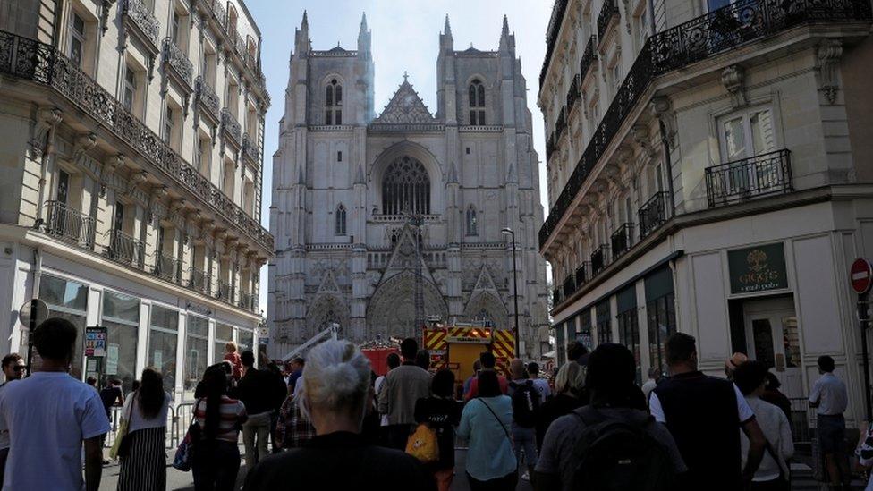 Onlookers gather at the scene of the fire