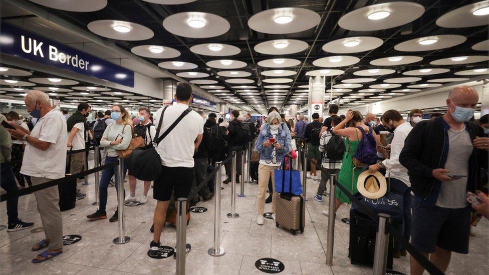 Arriving passengers queue at UK Border Control at the Terminal 5 at Heathrow Airport in London.