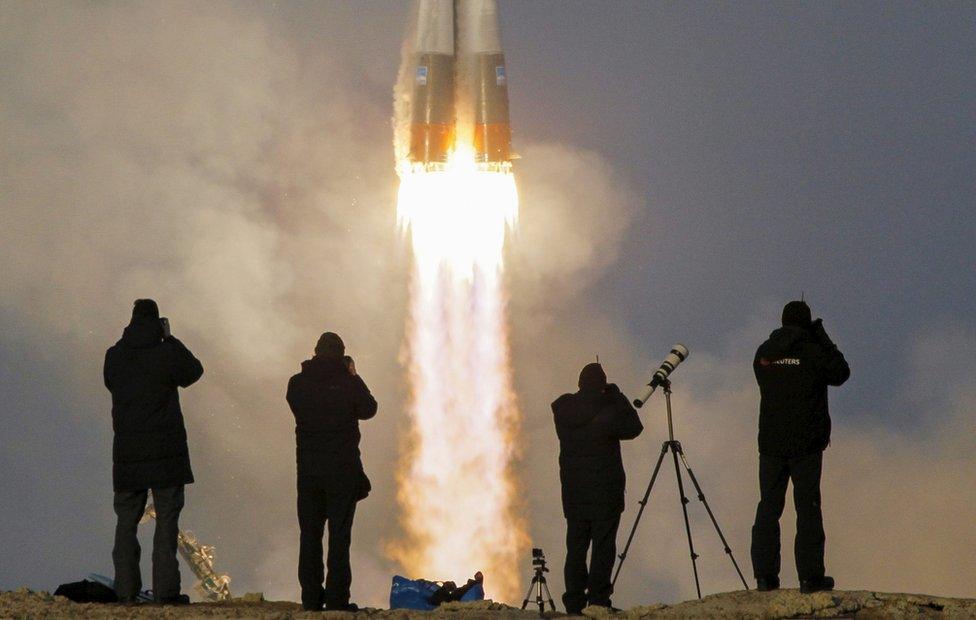 Photographers taking pictures of the Soyuz spacecraft launch