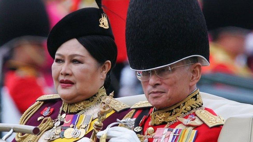 Thai King Bhumibol Adulyadej and Queen Sirikit parade on a limousine after they reviewed the honour guard in Bangkok on 2 December 2005.