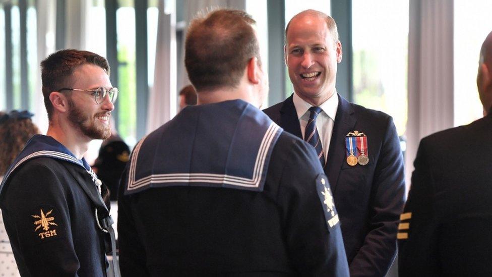 The Duke of Cambridge speaks with serving officers during the unveiling