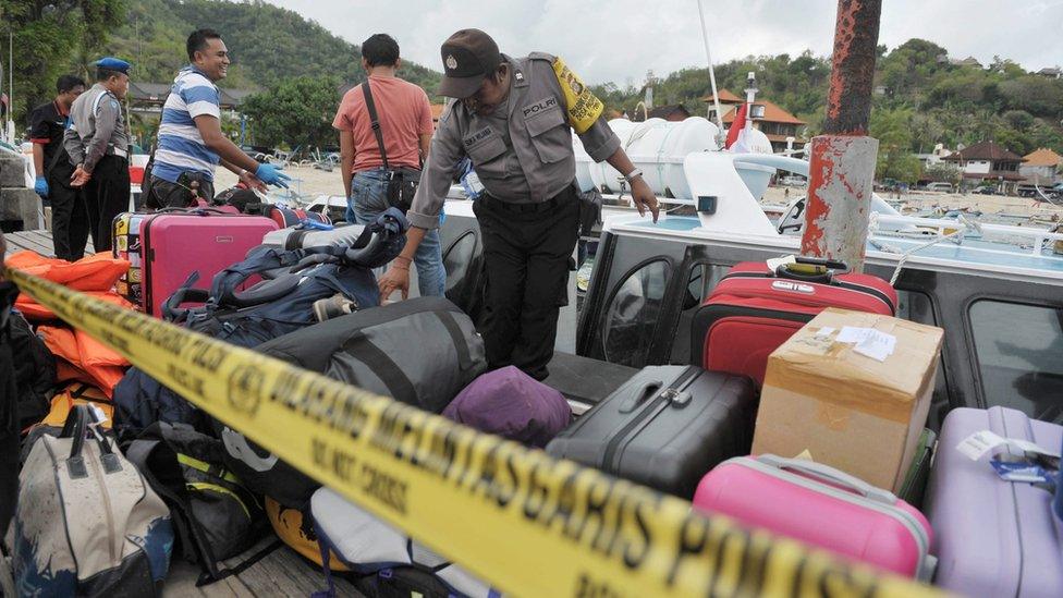 Indonesian police investigate the exploded tourist boat at Padang Bai port in eastern Bali, Indonesia, on 15 September