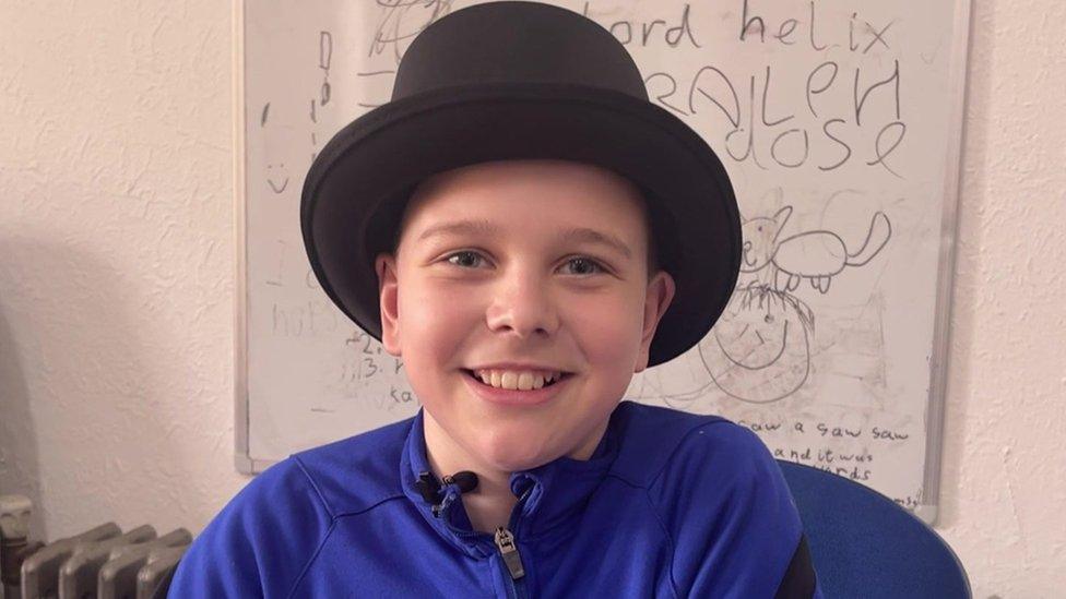 Boy smiling wearing a hat