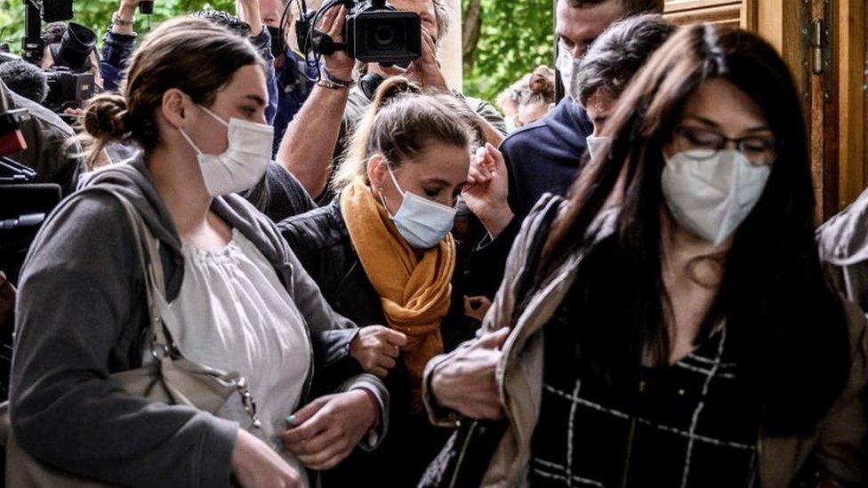 Valérie Bacot (C) arrives flanked by relatives and journalists at the Chalon-sur-Saone Courthouse, central-eastern France, on June 25, 2021