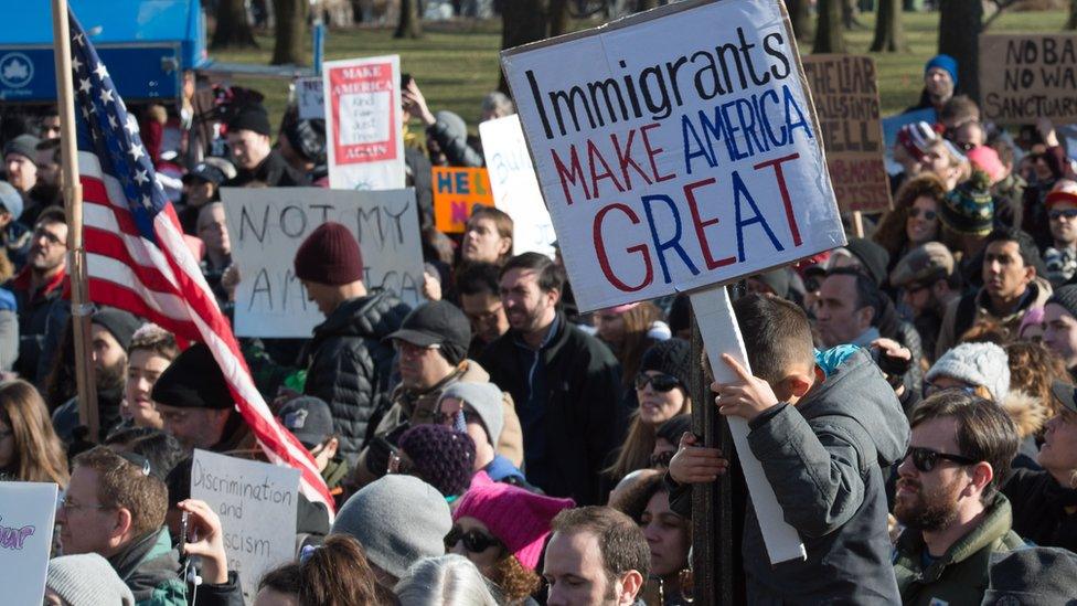 Protesters holding signs in favour of US immigration