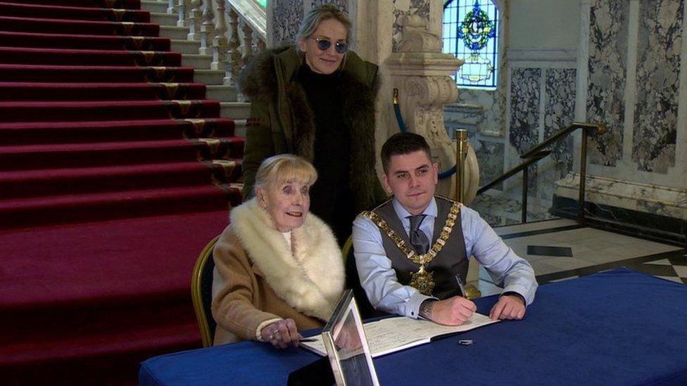 Sharon Stone, Betty Williams and Belfast Lord Mayor Daniel Baker signed the book of condolence