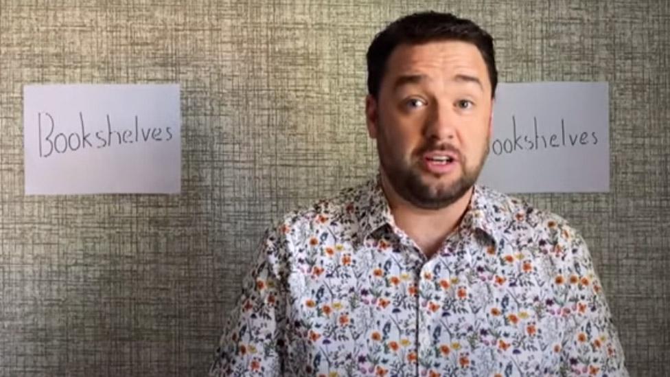 Jason Manford in front of his "bookshelves"