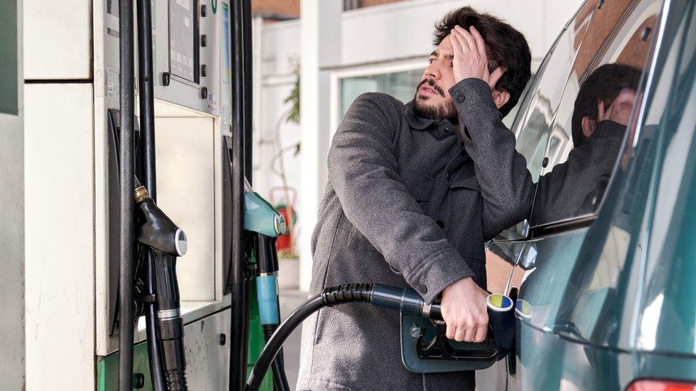 Man filling car with fuel