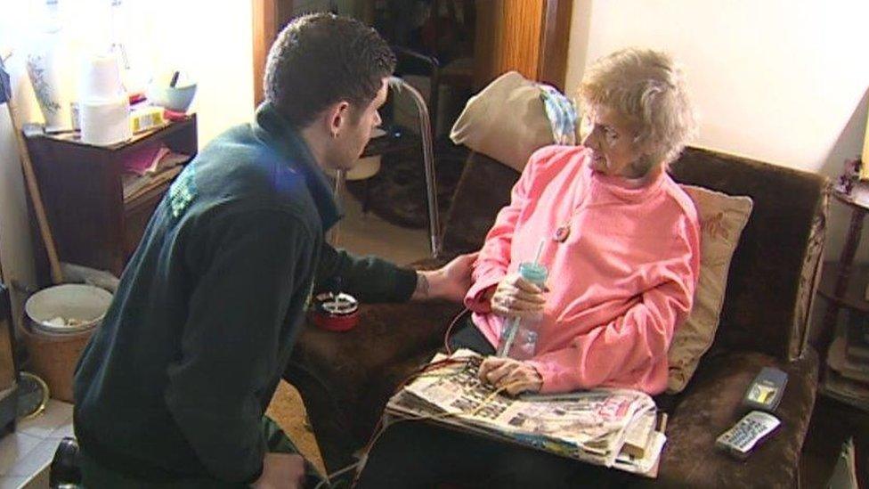 Paramedic attending to a patient at home