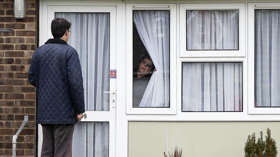 A woman looks at a canvasser