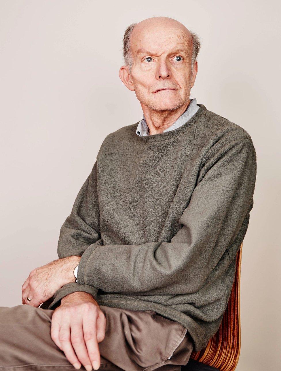 An elderly man sitting on a chair