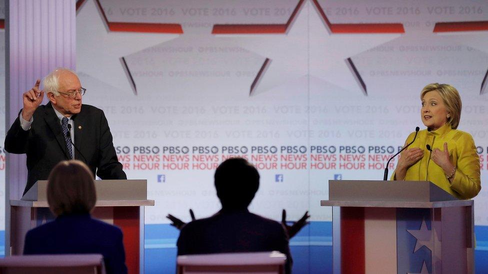 Democratic U.S. presidential candidate Senator Bernie Sanders and former Secretary of State Hillary Clinton discuss an issue at the PBS NewsHour Democratic presidential candidates debate in Milwaukee, Wisconsin, February 11, 2016