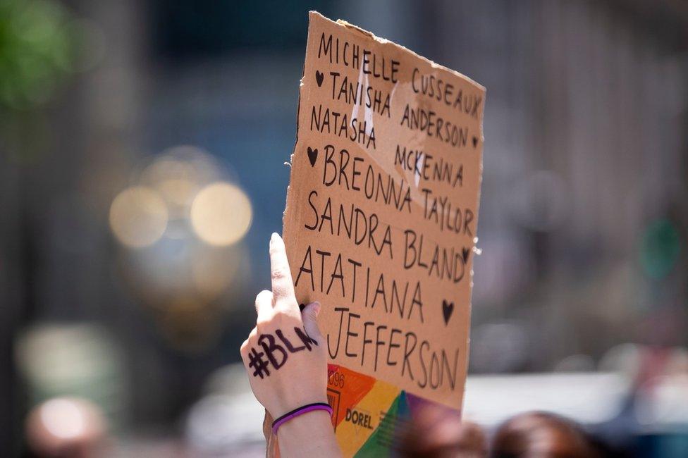 Protester in New York holding sign with Atatiana Jefferson's name