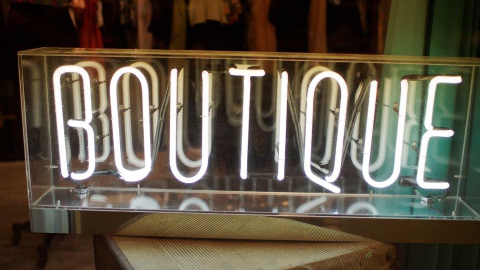 Sign in neon lights reads "Boutique"