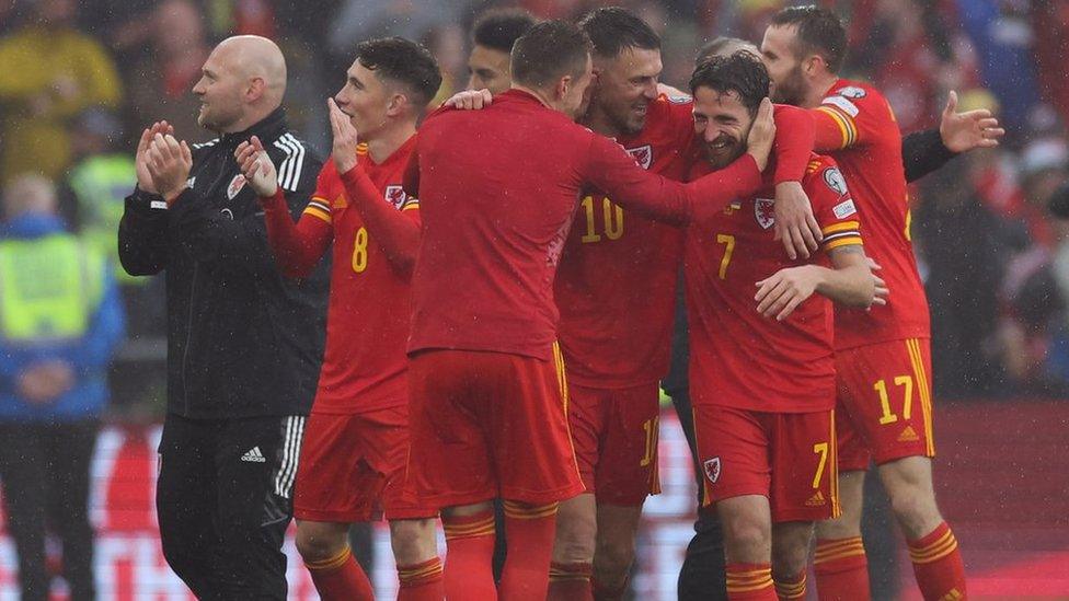 Joe Allen reacts to Wales qualifying for World Cup with his team-mates