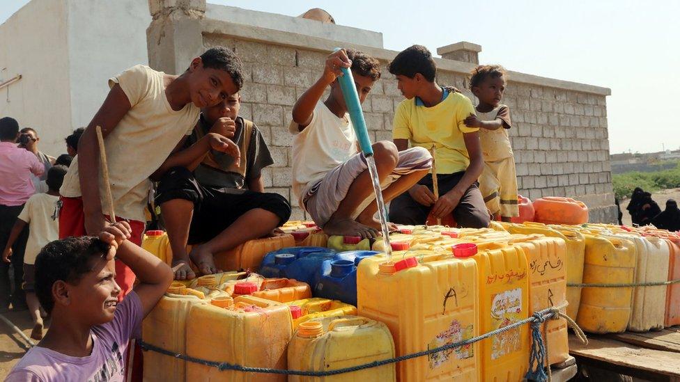 Yemeni children fill cans with water in an impoverished coastal village on outskirts of port city of Hodeidah, on October 18, 2016