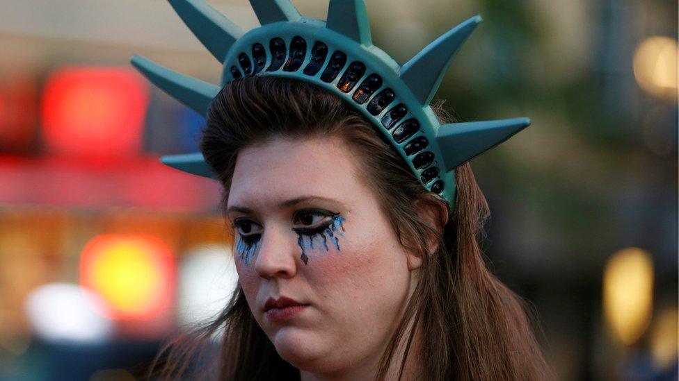 Woman protester dresses as Statue of Liberty