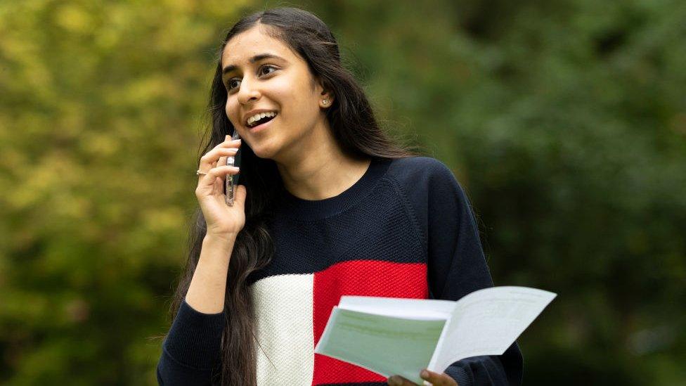 Girl opening GCSE results making a call