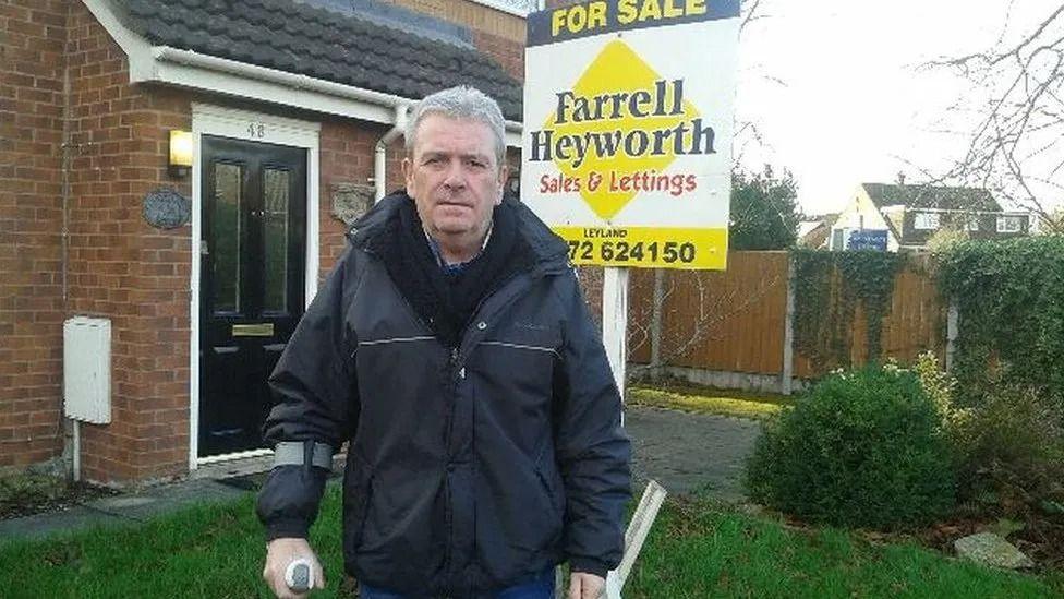 George Henderson, pictured in 2018, outside the home he was forced to sell