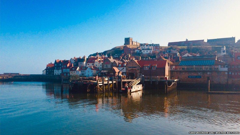 Cloudless sky by a coastal town