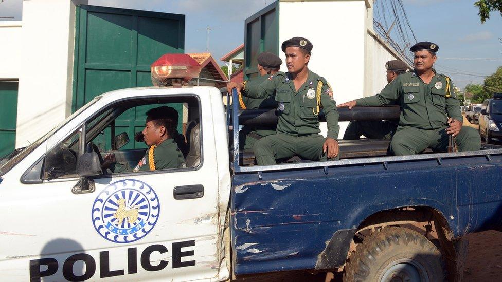 Cambodian police in the back of a pick-up truck