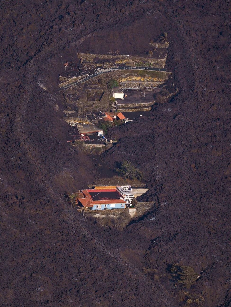 Houses surrounded by lava on the island of La Palma