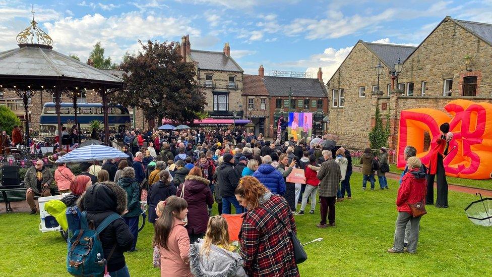 Crowd of people gathered in the Town Park at Beamish Museum