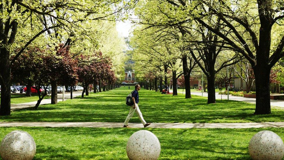 A student walking on campus grounds at the Australian National University in Canberra on 17 October 2003