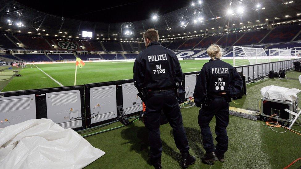 Two police officers at the stadium in Hannover, Germany, on 18 November 2015