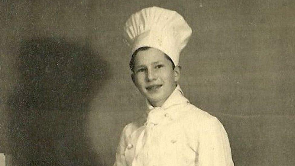 Former refugee Benjamin Abeles, who worked in hotels as a young man in Britain, wearing a chef's hat